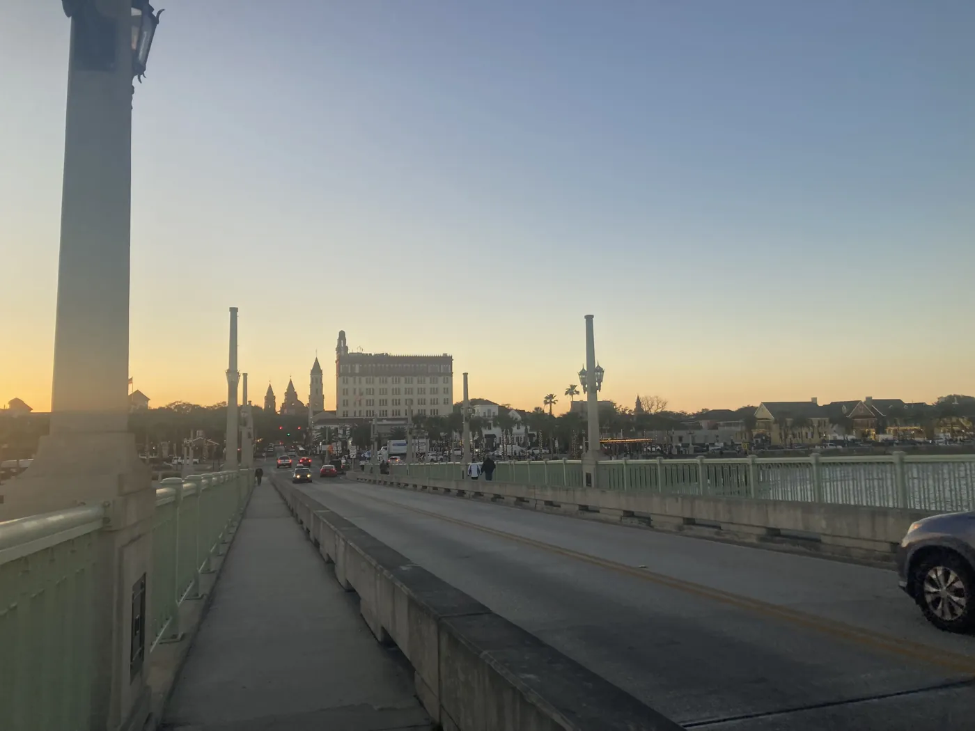 The Bridge of Lions stretching toward downtown St. Augustine at sunset.
